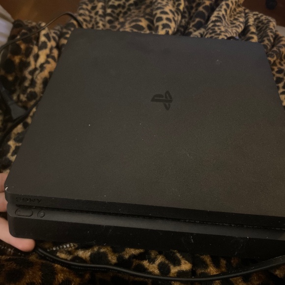 PLAY STATION 4 AND BLACK CONTROLLER